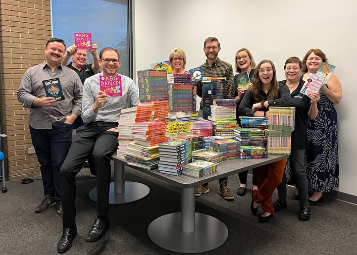 Tom Nehl employees with book drive books